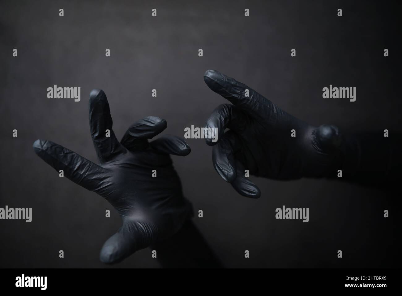 Background of hands in gloves. Black gloves. Hand gestures black gloves