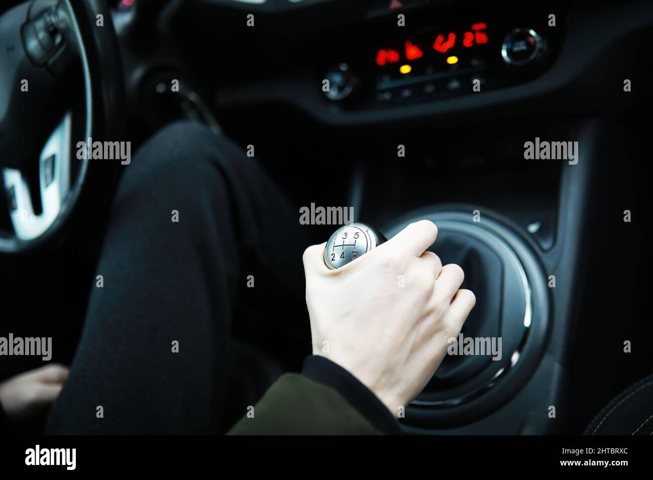 Hand on car gear knob. The driver switches the speed in the car. Hand