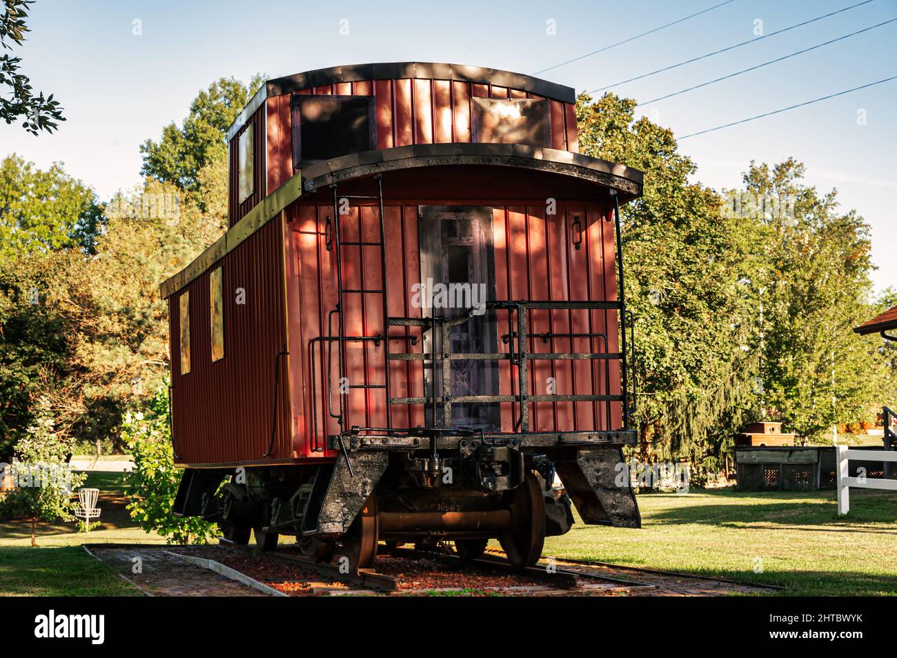 Old goods wagon in a park Stock Photo