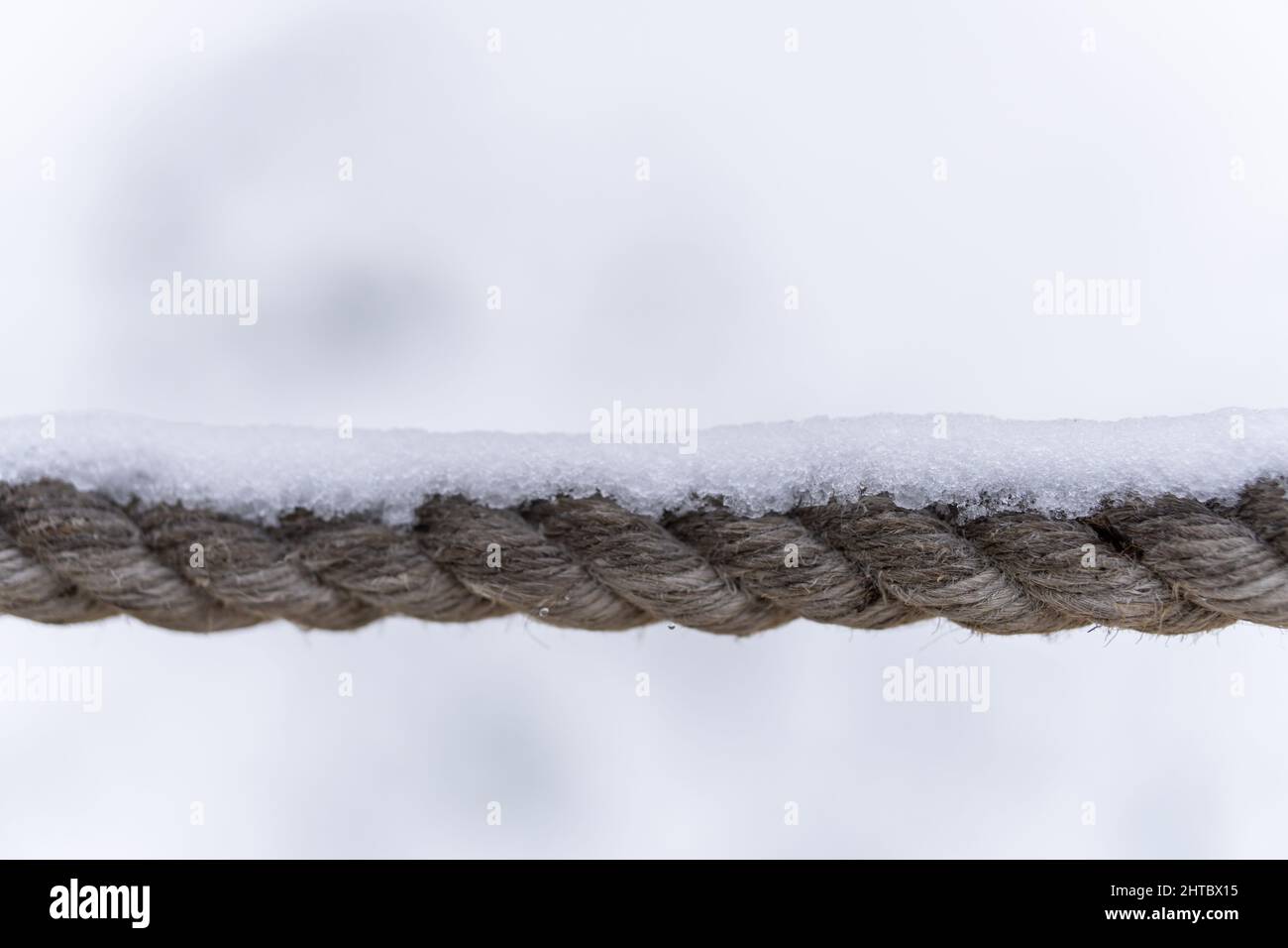 Closeup of a rope covered in snow Stock Photo - Alamy