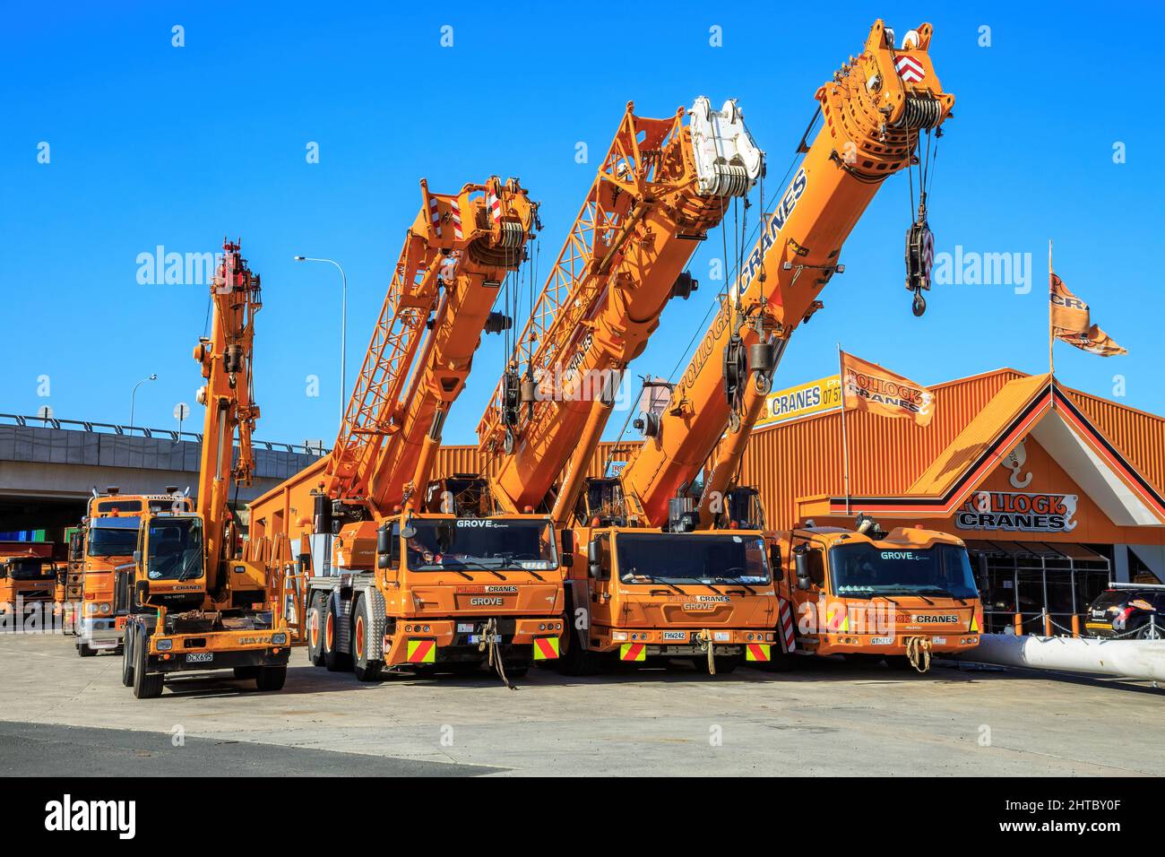 A row of Grove mobile cranes outside a hire facility in Tauranga, New Zealand Stock Photo