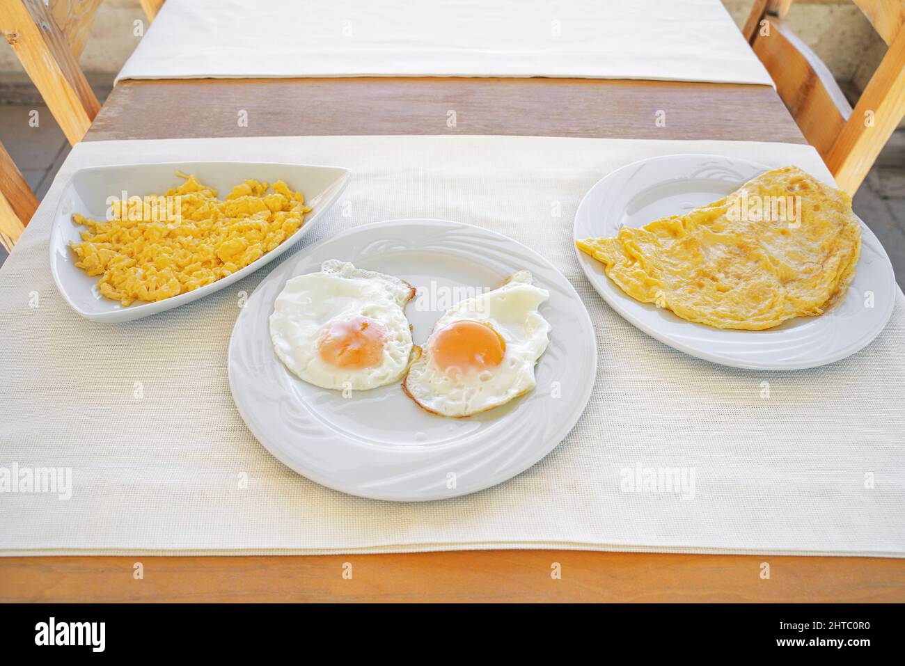 Various ways to cook chicken eggs. Boiled omelet, scrambled eggs and fried omelet. Close-up. Stock Photo