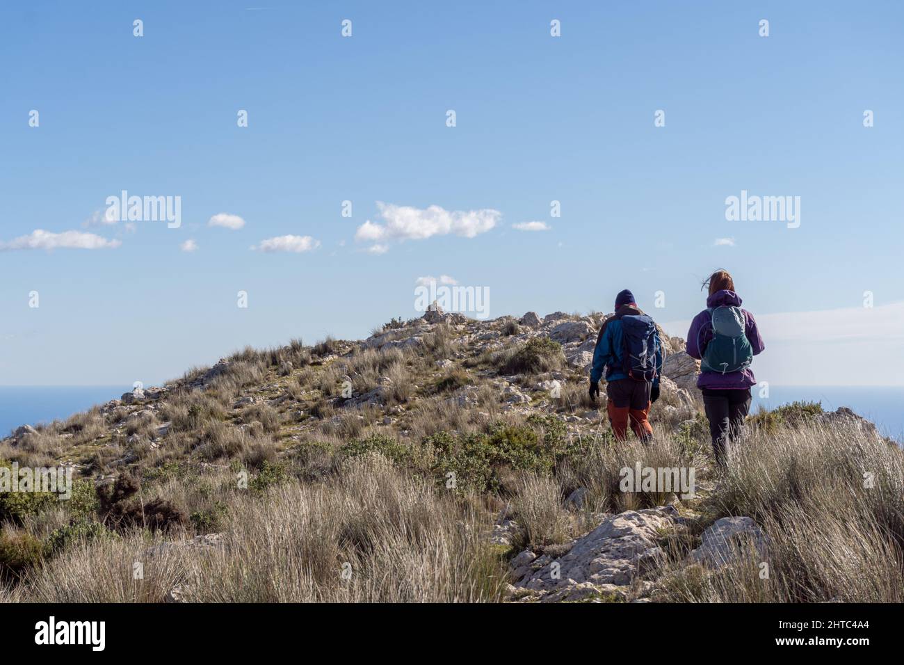 Beautiful view of two hikers on top of a mountain Stock Photo - Alamy