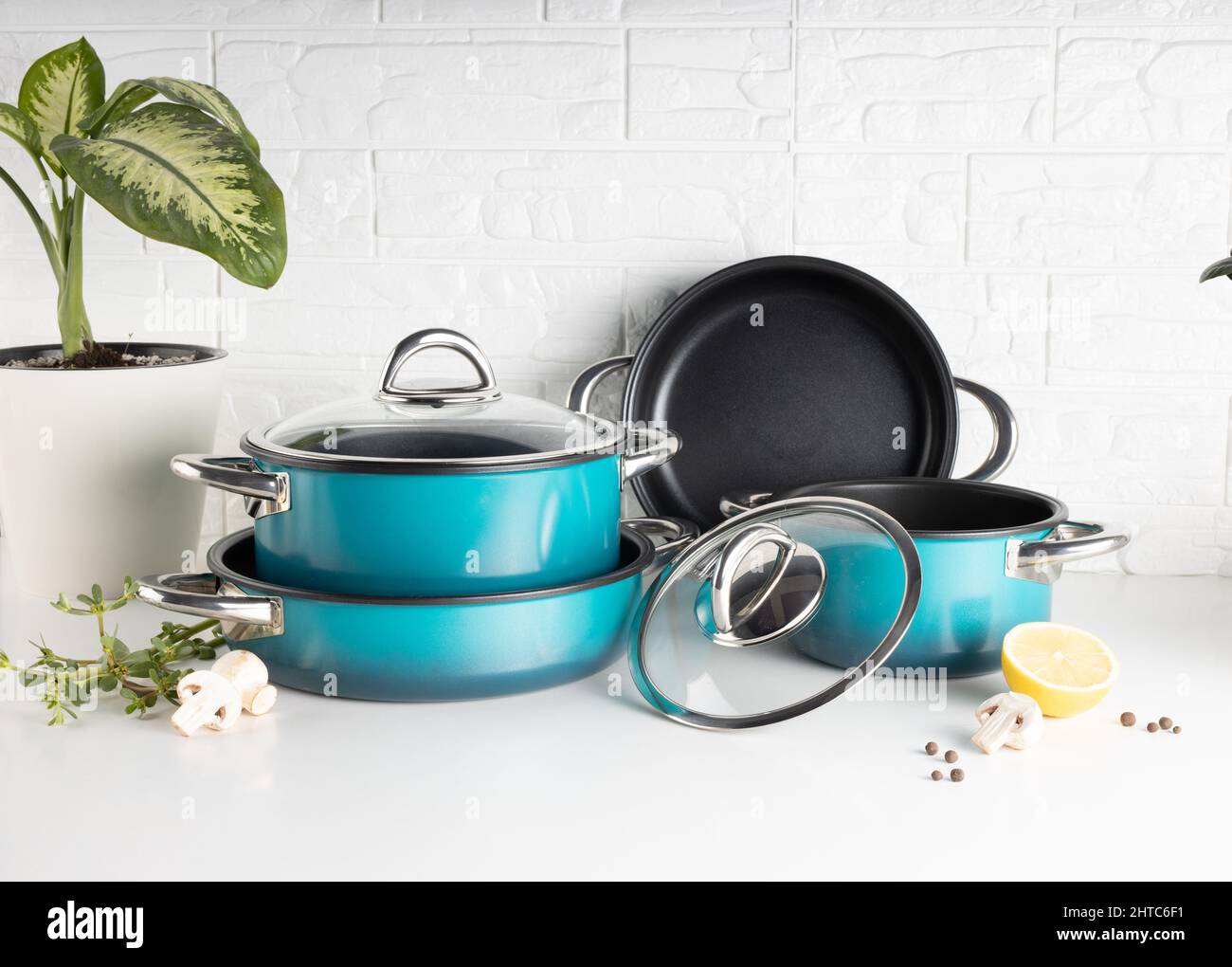 Metallic cooking pots and trays in a white background Stock Photo - Alamy