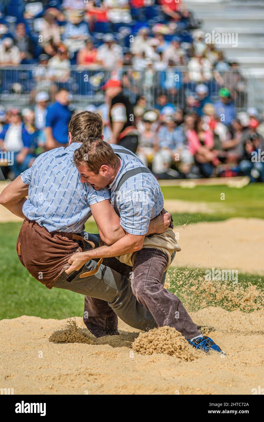 Schwingen (Swiss wrestling) at folklore festival, with spectators in background Stock Photo