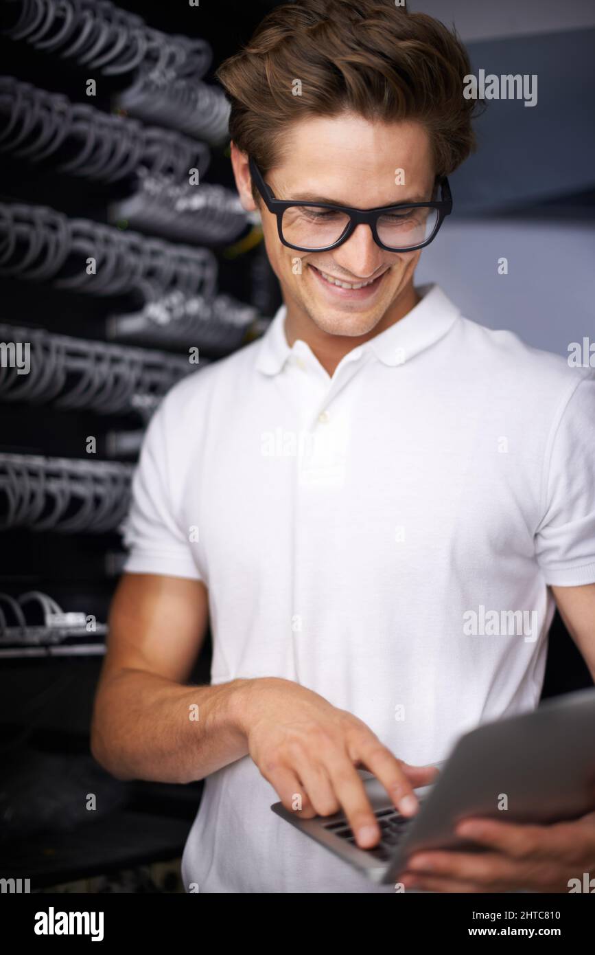 Taking care of your network needs. A young technician working on a server. Stock Photo