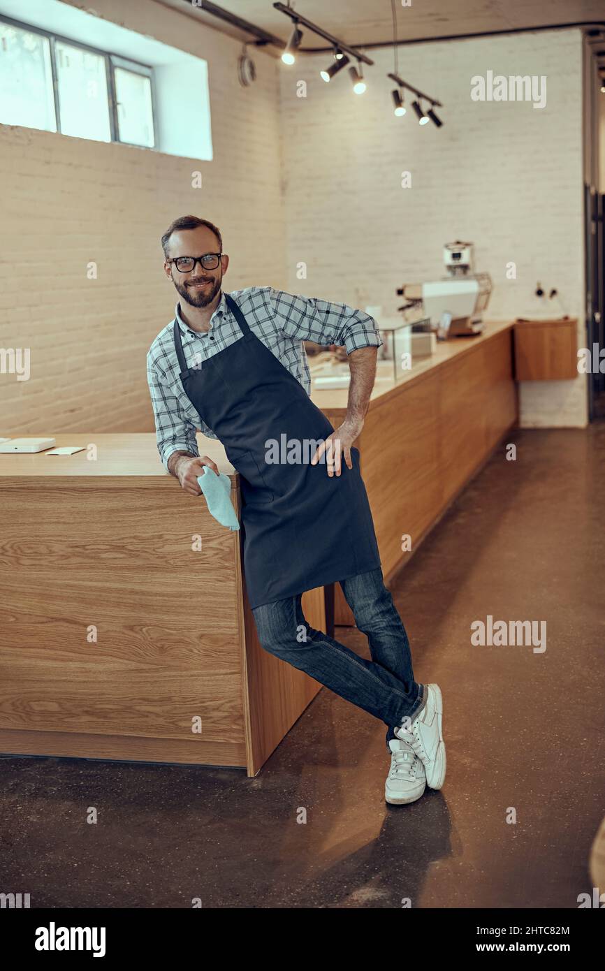 Leaning on wooden counter hi-res stock photography and images - Alamy