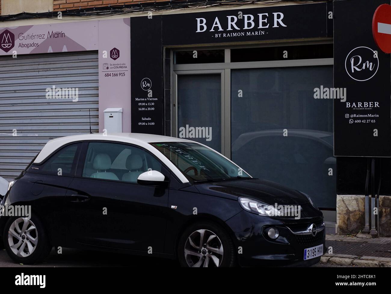 A view of a car parked in front of barber shop Stock Photo Alamy
