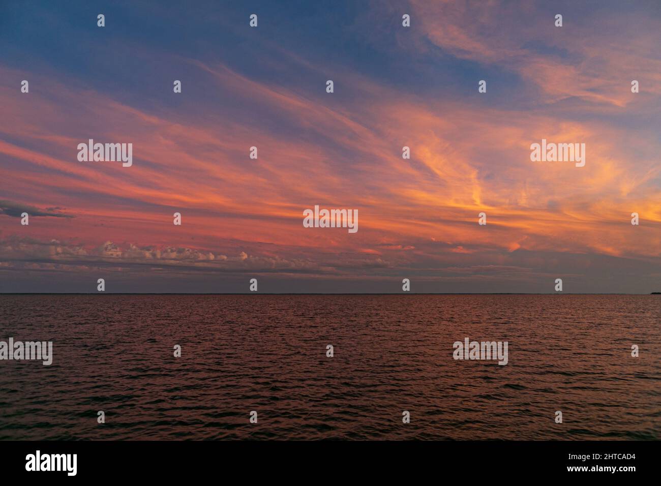 Beautiful sunset sky with thin clouds over a sea Stock Photo - Alamy