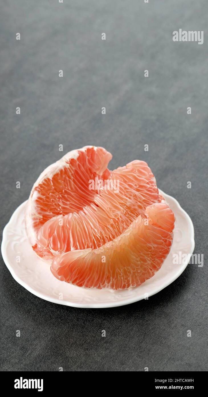 Pomelo Fruit on Plate. Grapefruit, jeruk Bali, or Bali Pomelo Fruit. Large Oranges in Indonesia are known as Bali Oranges or Jeruk Bali. Stock Photo