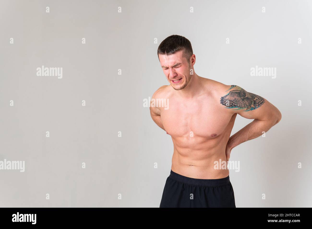 A man back pain keeps his hand on his back back sore person massage