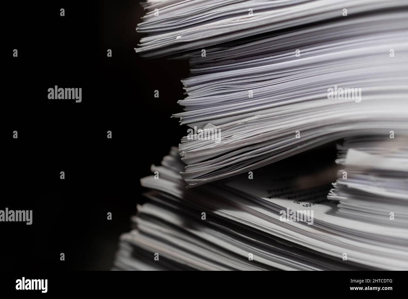 Pile of paper documents on a black background Stock Photo Alamy