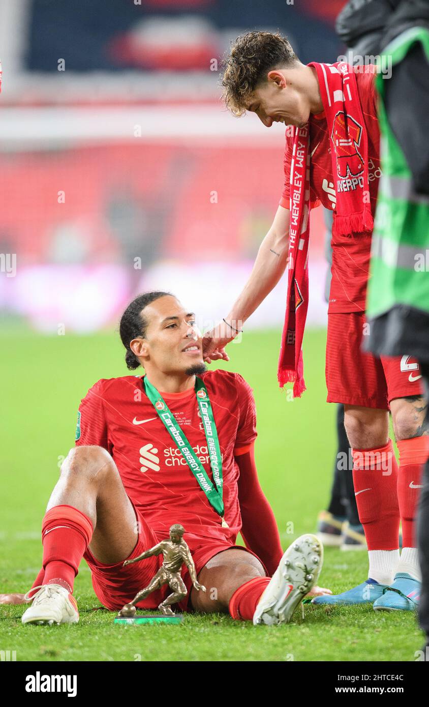 London, UK. 27th Feb, 2022. Chelsea v Liverpool - Carabao Cup - Final - Wembley Stadium Virgil Van Dijk sits quietly wth his Man Of The Match trophy whilst his team-mates celebrate aroubd him after winning the Carabao Cup Final at Wembley Stadium Picture Credit : Credit: Mark Pain/Alamy Live News Stock Photo