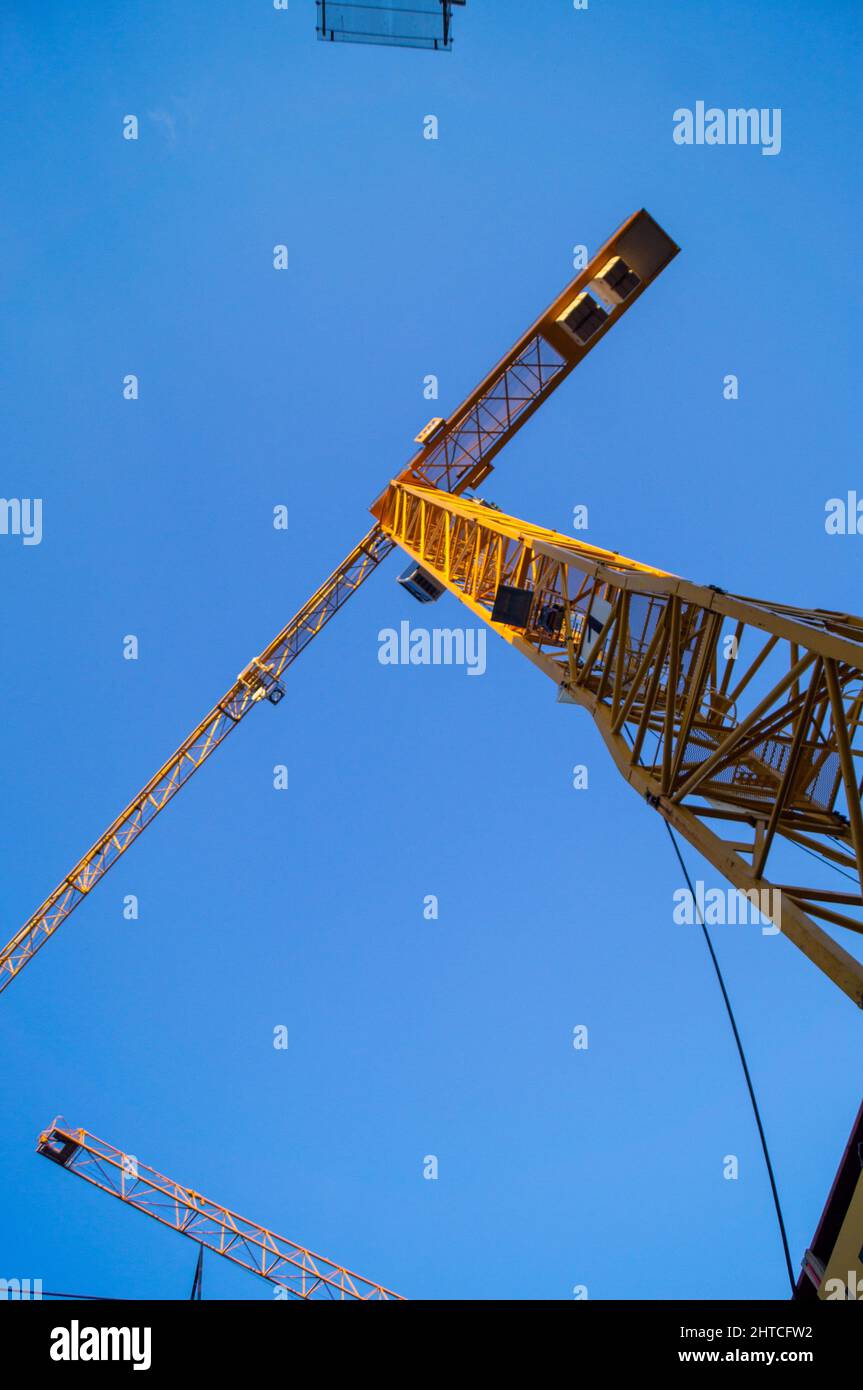 Low angle shot of a construction crane tower in the blue sky background ...