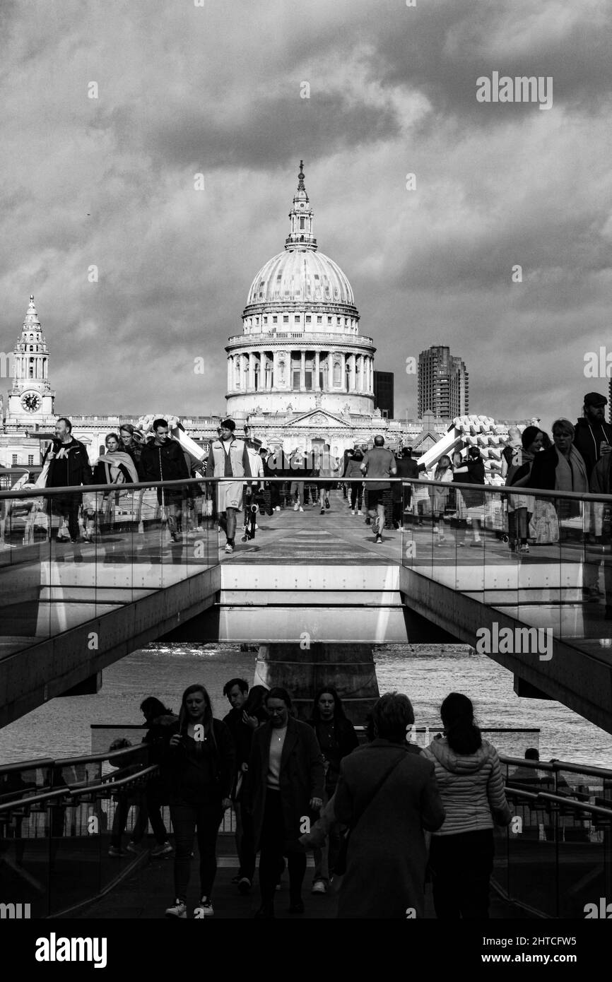 Vertical grayscale view of the St Paul's Cathedral with people in the foreground, London, the UK Stock Photo