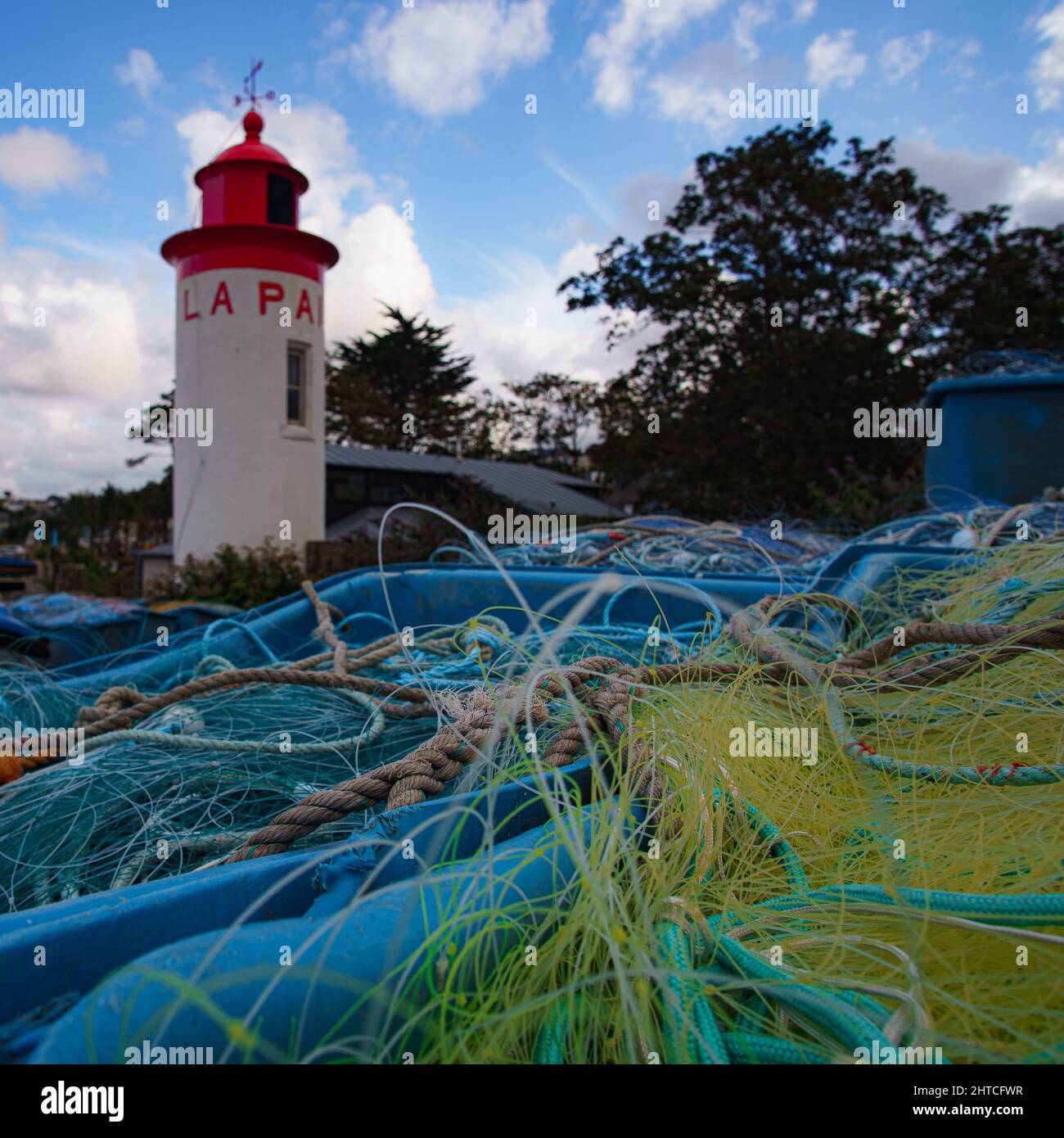 Scattered ropes on the grass in the background of a lighthouse Stock ...