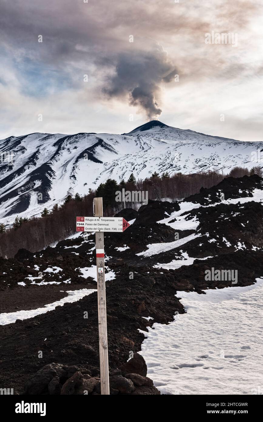A footpath sign high on the rugged slopes of Mount Etna, Sicily, Italy. There are many long distance hiking trails around the volcano Stock Photo