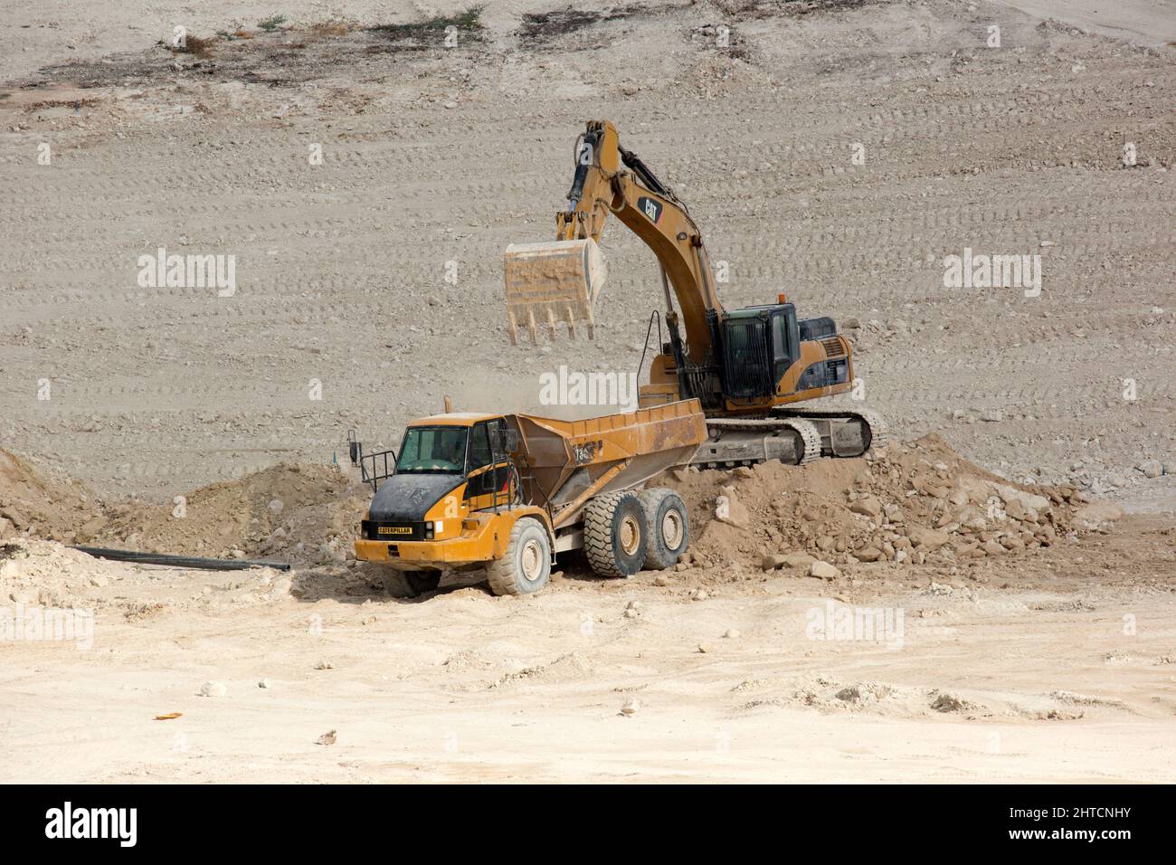 Heavy earth moving equipment clearing the ground for a large scale civil engineering project Stock Photo