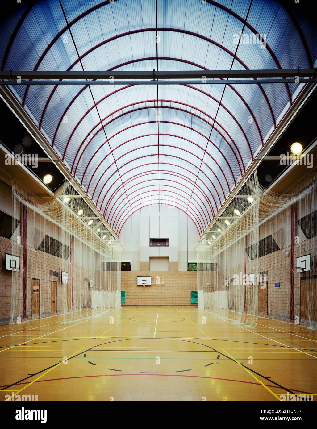 Perronet Thompson School, Wawne Road, Bransholme, Kingston upon Hull, 17/04/1989. The interior of the sports hall at Perronet Thompson School with nets set up for cricket practice, showing the glazed barrel vaulted ceiling. Laing's Yorkshire Region division began work on site in September 1986 and the building was completed in June 1988.  Bransholme was one of the largest local authority housing estates in Britain at the time and the school was equipped with enhanced facilities for the use of the whole community.  These included the larger lending library, the 'Bransholme Theatre', meetings ro Stock Photo