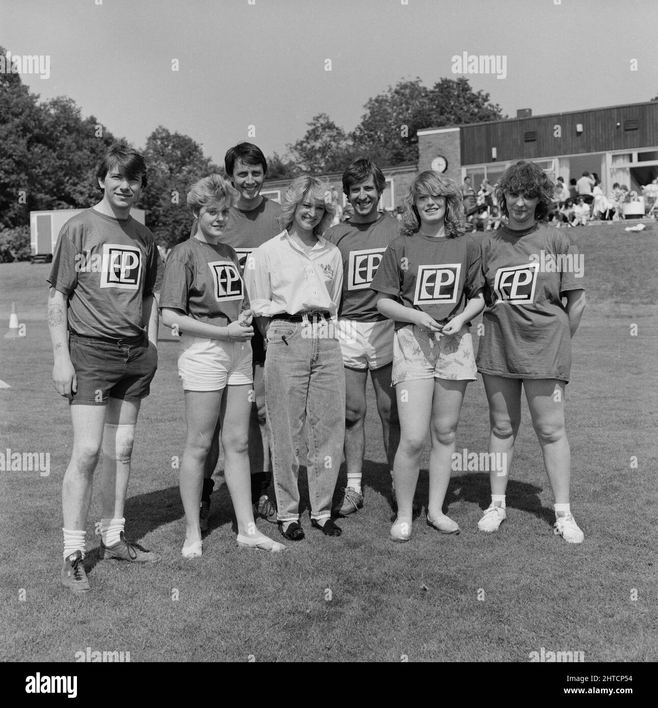 Laing Sports Ground, Rowley Lane, Elstree, Barnet, London, 20/06/1987. The EPL 'Somnambulists' team in the 'It's a Knockout' style competition posing with the Eastenders actor Gillian Taylforth at the 1987 Family Day at Laing's Sports Ground. Attractions at that year's Family Day included; hot air balloon rides, helicopter rides, a bouncy castle and fairground rides, stalls, an 'It's a Knockout' style competition and tennis and six-a-side football tournaments.  Cast members from Eastenders made a guest appearance and entered a side in the football competition.  Six teams entered the 'It's a Kn Stock Photo