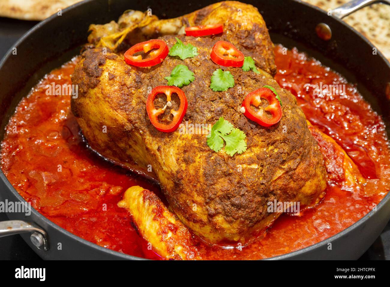 one-pot spiced roast chicken with garnish Stock Photo