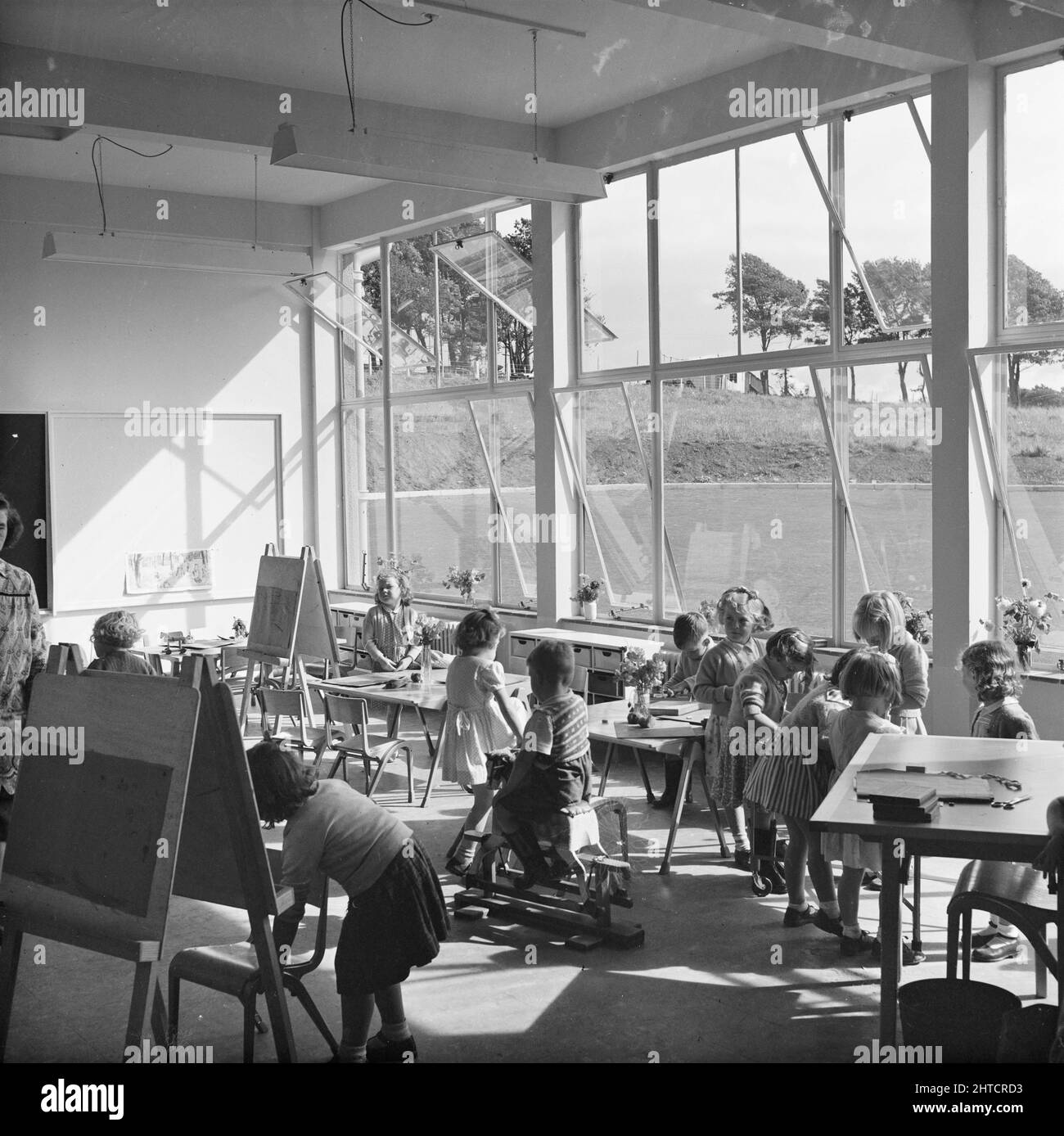 Valley Primary School, Whinlatter Road, Copeland, Cumbria, 03/09/1952. Schoolchildren engaged in various activities in a classroom at Valley Primary School. Valley Primary School was built by Laing as part of the Valley housing scheme in Whitehaven and was also one of four schools they completed in 1952 in the Carlisle and West Cumberland area. Stock Photo
