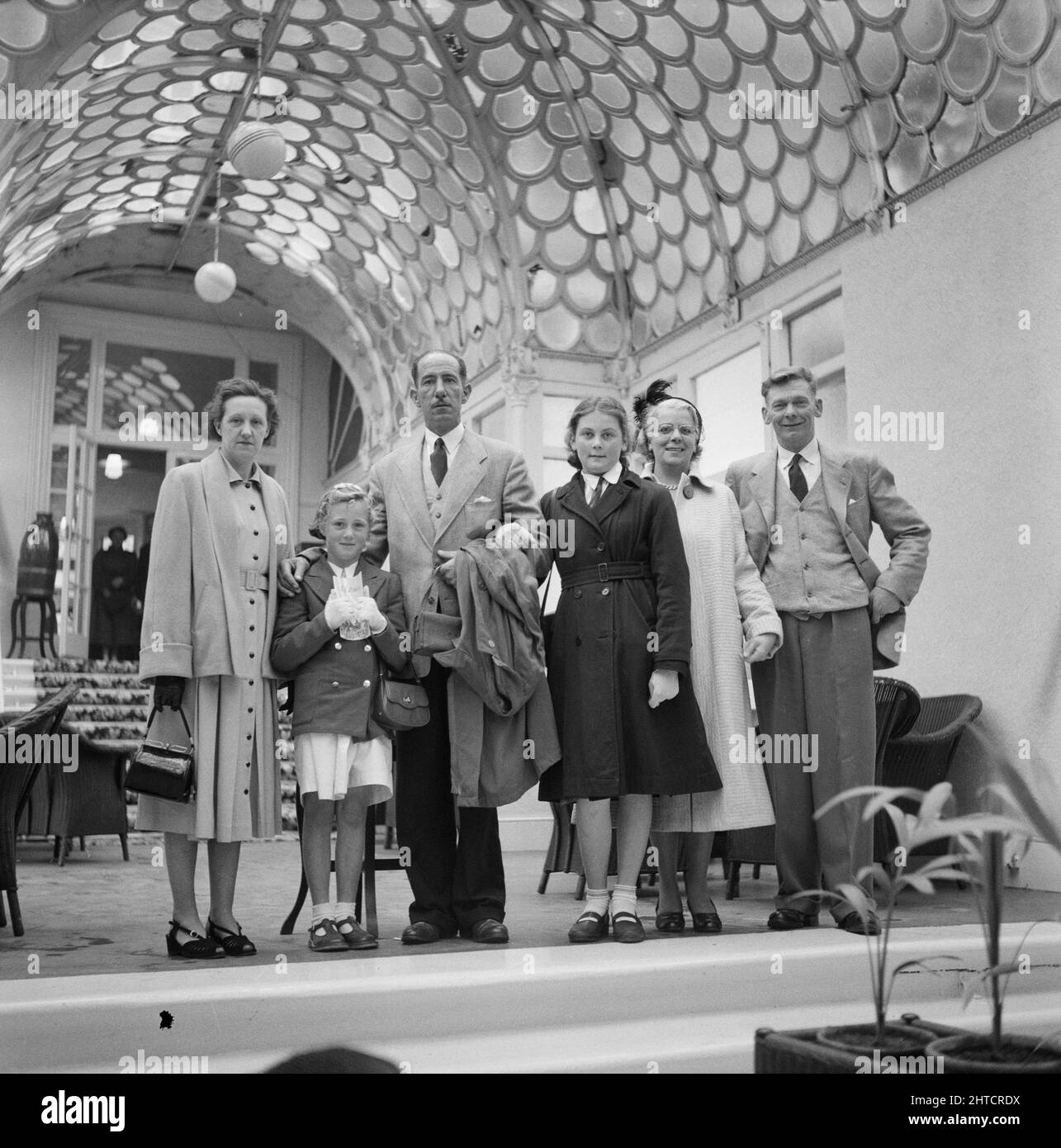 Victoria Pavilion, Wilder Road, Ilfracombe, North Devon, Devon, 12/06/1954. A group of adults and children posed in the Victoria Pavilion during a Laing staff trip to Ilfracombe. In 1947, after a seven year break, Laing had resurrected their 'Area Outings' for staff and their families, with trips taking place in May and June. In 1954, there were seven outings planned to take place over five weeks in May and June. This trip was for staff and their families from the South-West and South Wales including Bristol, Portishead, Plymouth and South Wales. Stock Photo