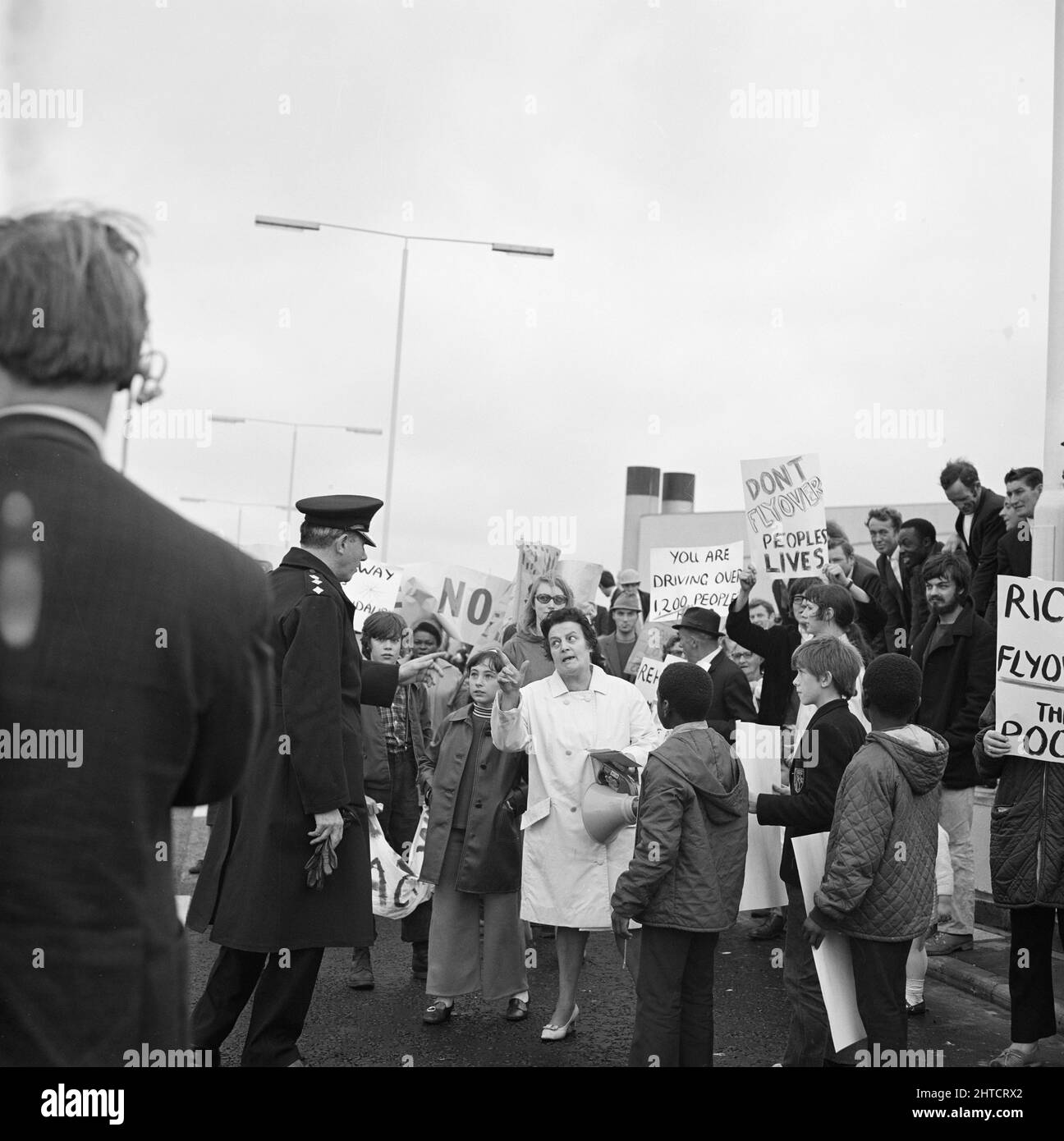 Westway Flyover, A40, Paddington, City of Westminster, London, 28/07/1970. A woman confronting a police officer during a demonstration against the opening of the Westway Flyover. Acklam Road was the focus of protests against the Westway by local residents. Houses along one side of the street had been demolished to make way for the flyover. At a reception held earlier that day at the Lord&#x2019;s Tavern, George Clark, leader of the residents&#x2019; social rights committee, had presented their objections to the Minister of Transport and representatives from the Greater London Council. By Septe Stock Photo