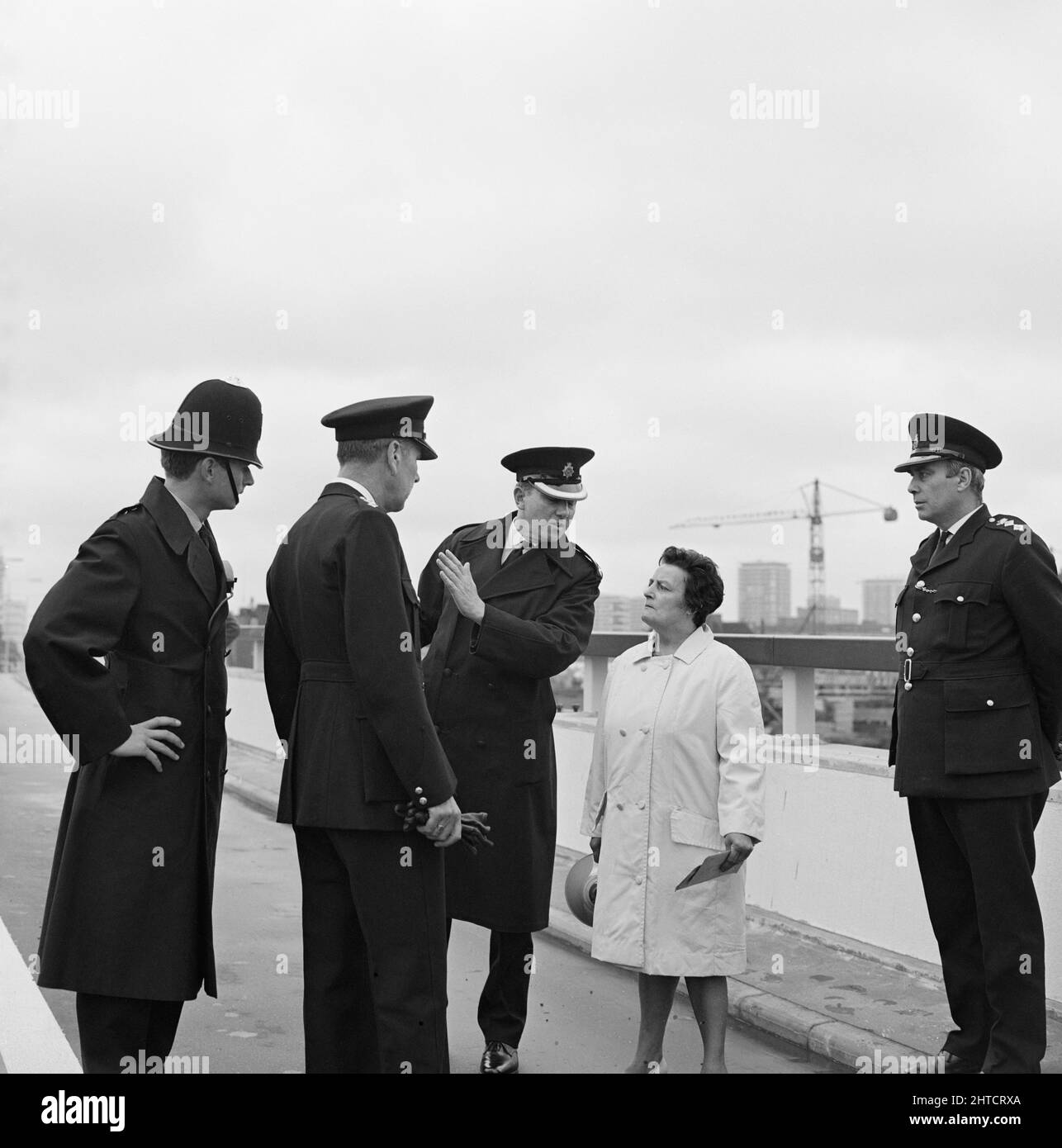Westway Flyover, A40, Paddington, City of Westminster, London, 28/07/1970. Four police officers talking with the leader of the demonstrators protesting against the opening of the Westway Flyover. Acklam Road was the focus of protests against the Westway by local residents. Houses along one side of the street had been demolished to make way for the flyover and at a reception held earlier that day at the Lord&#x2019;s Tavern, George Clark, leader of the residents&#x2019; social rights committee, had presented their objections to the Minister of Transport and representatives from the Greater Lond Stock Photo