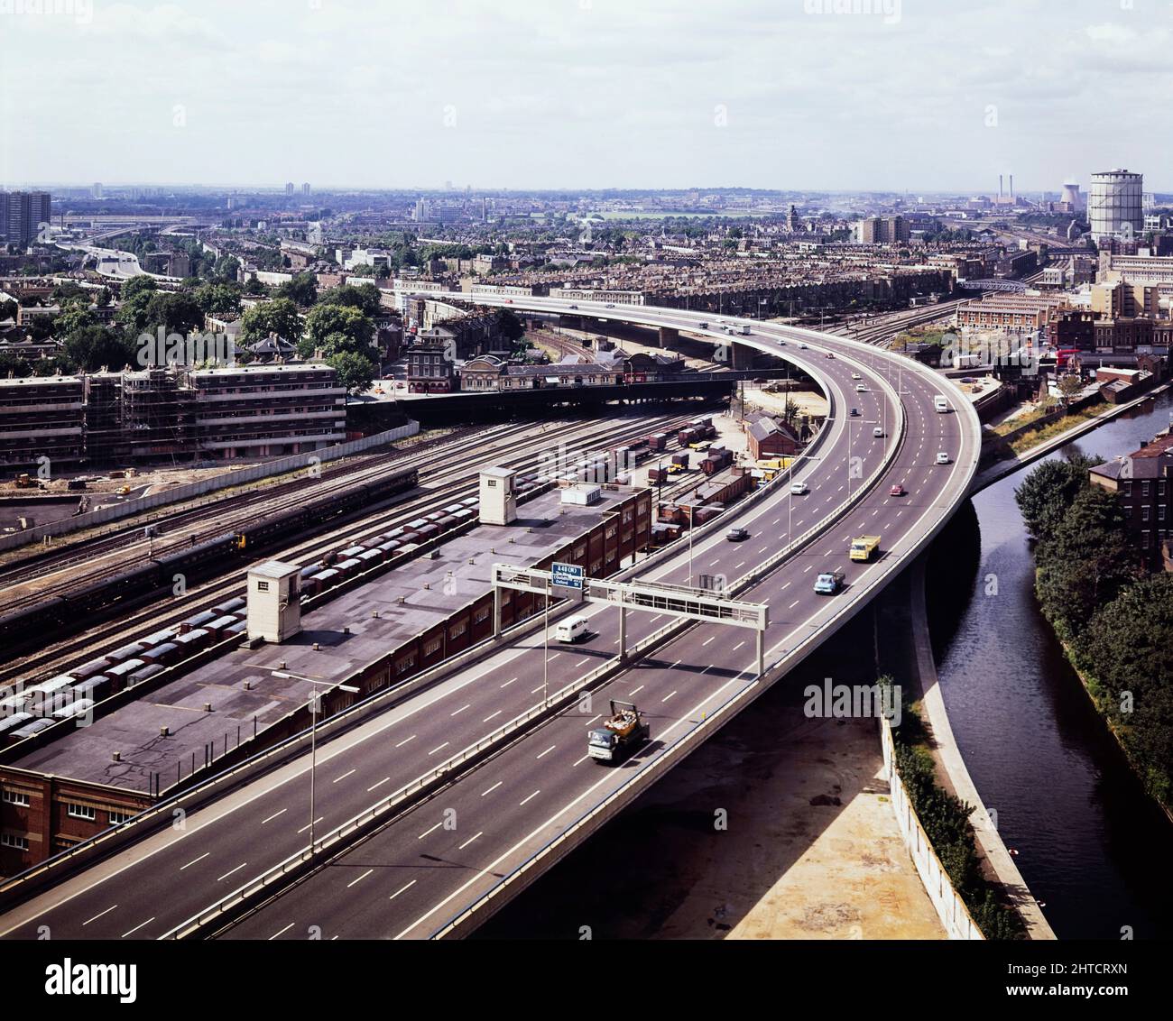 Westway Flyover, A40, Paddington, City of Westminster, London, 01/09/1971. An elevated view looking west along the route of the Westway Flyover, showing it overhanging the Grand Union Canal and curving to cross the railway near Westbourne Park Station. Work on site for the Western Avenue Extension began on 1st September 1966, and the Westway as it became known was officially opened on 28th July 1970. The elevated highway connecting the A40 at White City to Marylebone Road in Paddington, at around 2 &#xbd; miles, was the longest in Europe. This photograph was taken at grid reference TQ249118183 Stock Photo