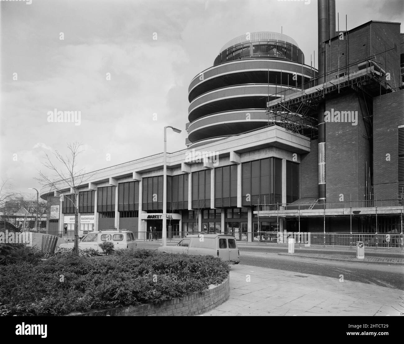 Wood Green Shopping City, Haringey, London, 11/02/1980. A view of the Mayes Road entrance to the Market Hall at Wood Green Shopping City, with the spiral ramps of the west car park rising above. Wood Green Shopping City, later renamed The Mall Wood Green, is a large shopping centre and housing complex. The site has a unique design, with the A105 (High Road) running through its centre, and a housing complex known as 'Sky City' built on top of the shop units. Laing's London Region were responsible for the construction of various sections of the site in the 1970s to early 1980s. The most notable Stock Photo
