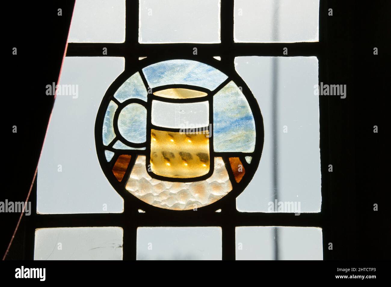 The Gatehouse, Dereham Road, Norwich, Norfolk, 2015. Detail of a stained-glass roundel in one of the public house's windows, depicting a tankard of ale. Stock Photo