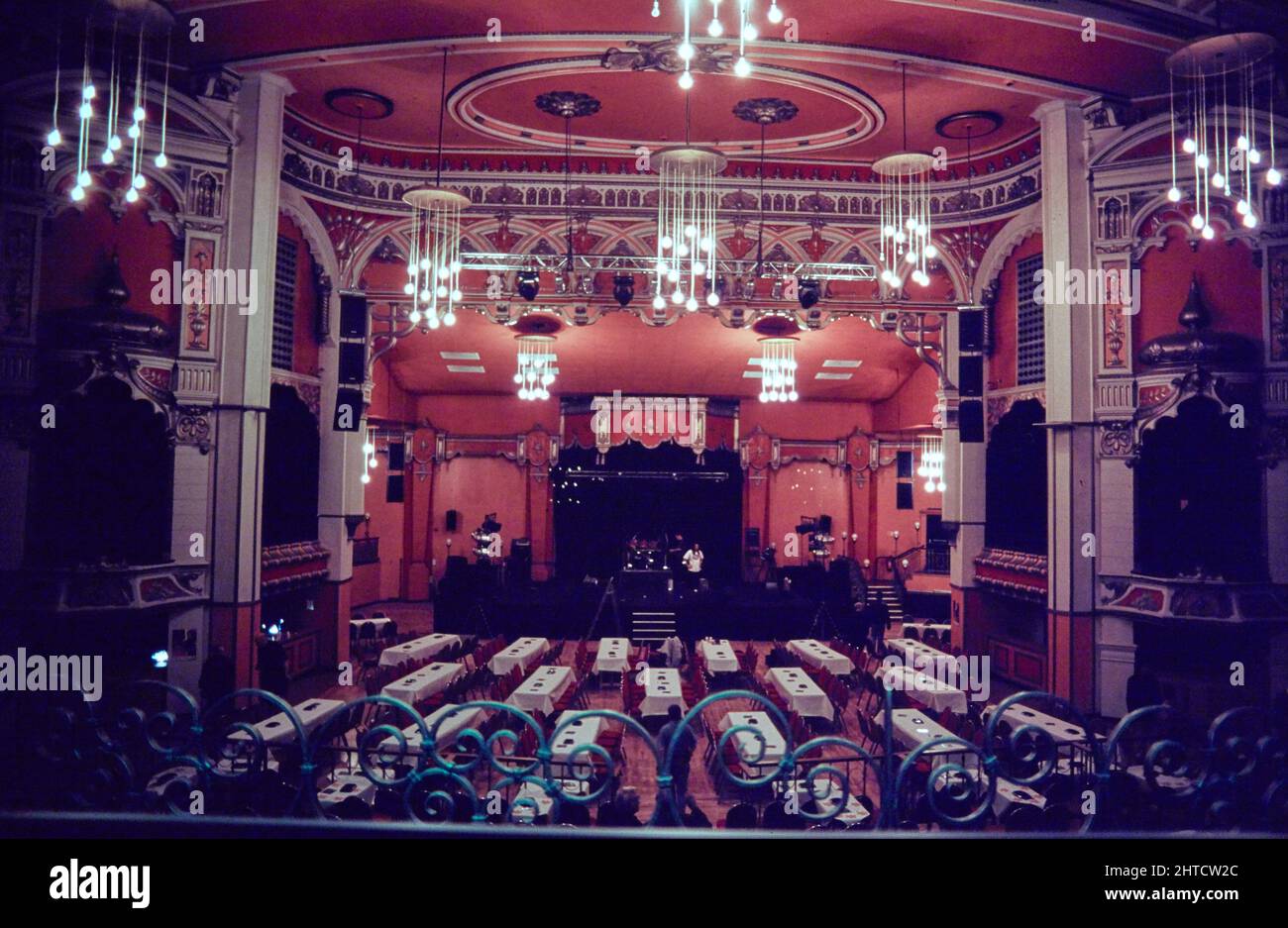 Olypmia Theatre, West Derby Road, Everton, Liverpool, 1990-2015. A view from the circle looking across the auditorium and former stage in the Olympia Theatre, with the space filled with tables. The Olympia Theatre opened in 1905. In 1925 it was briefly closed and reopened as a cinema. It closed in 1939 for the duration of the Second World War. The building became a ballroom in 1948, and then a bingo hall from 1964 until 1982, and then 1987-1990. In the 21st century it operated as a live events venue. Stock Photo