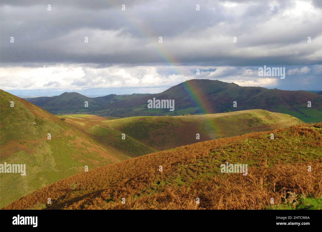 Long Mynd, Church Stretton, Shropshire, 2010. General view looking across the hills of the Long Mynd, with the end of a rainbow visible in the foreground. Stock Photo