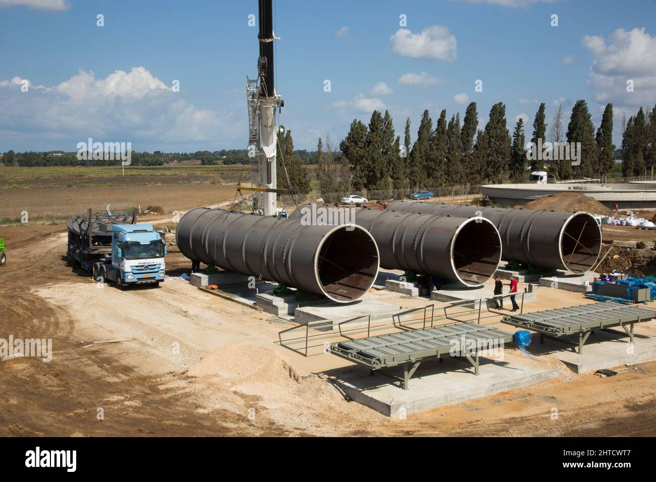 Large diameter water pipes are being placed in the ground Stock Photo