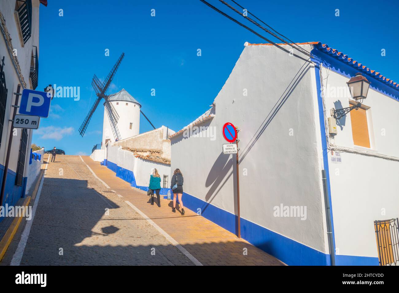 Street and windmill. Campo de Criptana, Ciudad Real province, Castilla La Mancha, Spain. Stock Photo