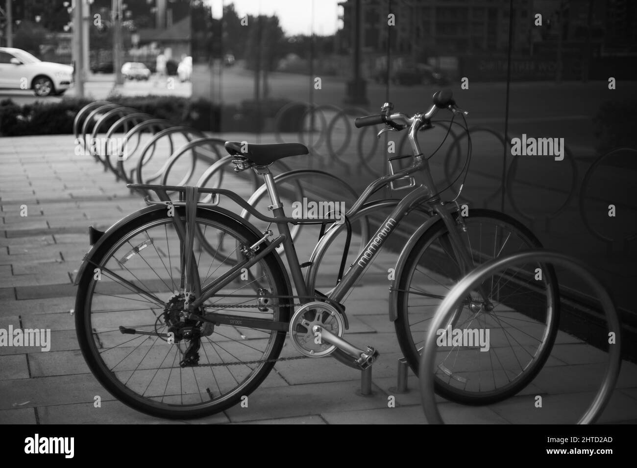 Lone bicycle parked in the street in black and white Stock Photo