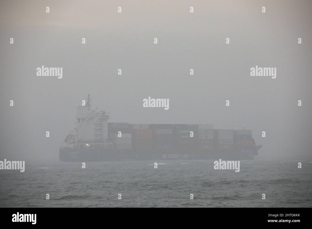 Bullens Bay, Cork, Ireland. 28th February, 2022. Container ship BG Emerald is barely visible in fog as she lies at anchorage in Bullens Bay off the Old Head of Kinsale, Co. Cork, Ireland.  - Credit; David Creedon / Alamy Live News Stock Photo