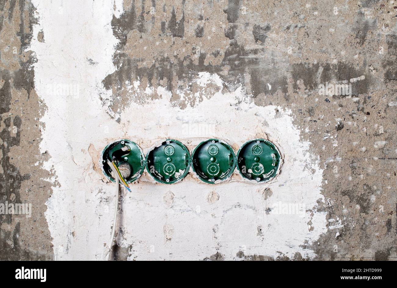Green electrical sockets embedded in a concrete wall Stock Photo Alamy