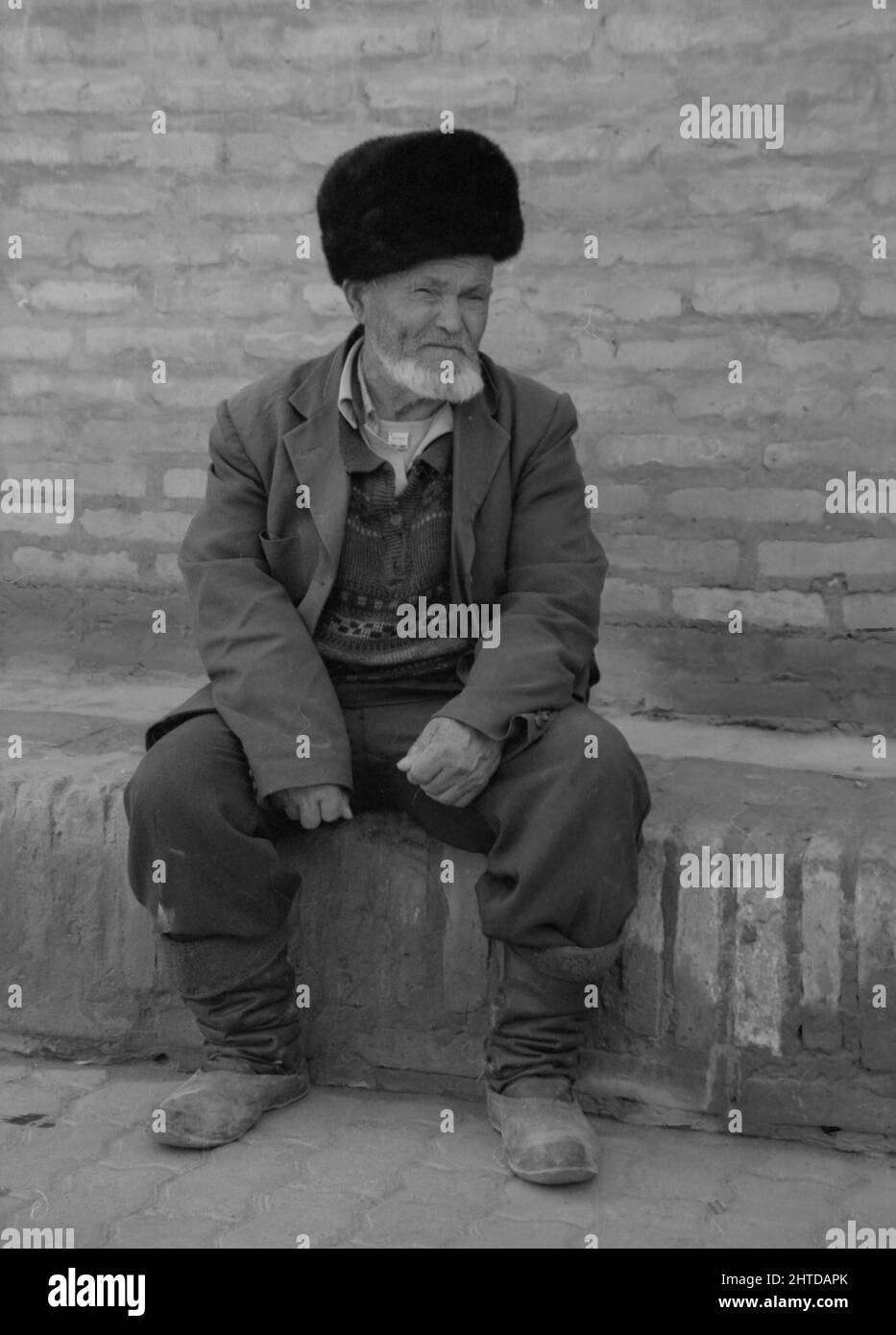 Elderly man resting on the street Stock Photo