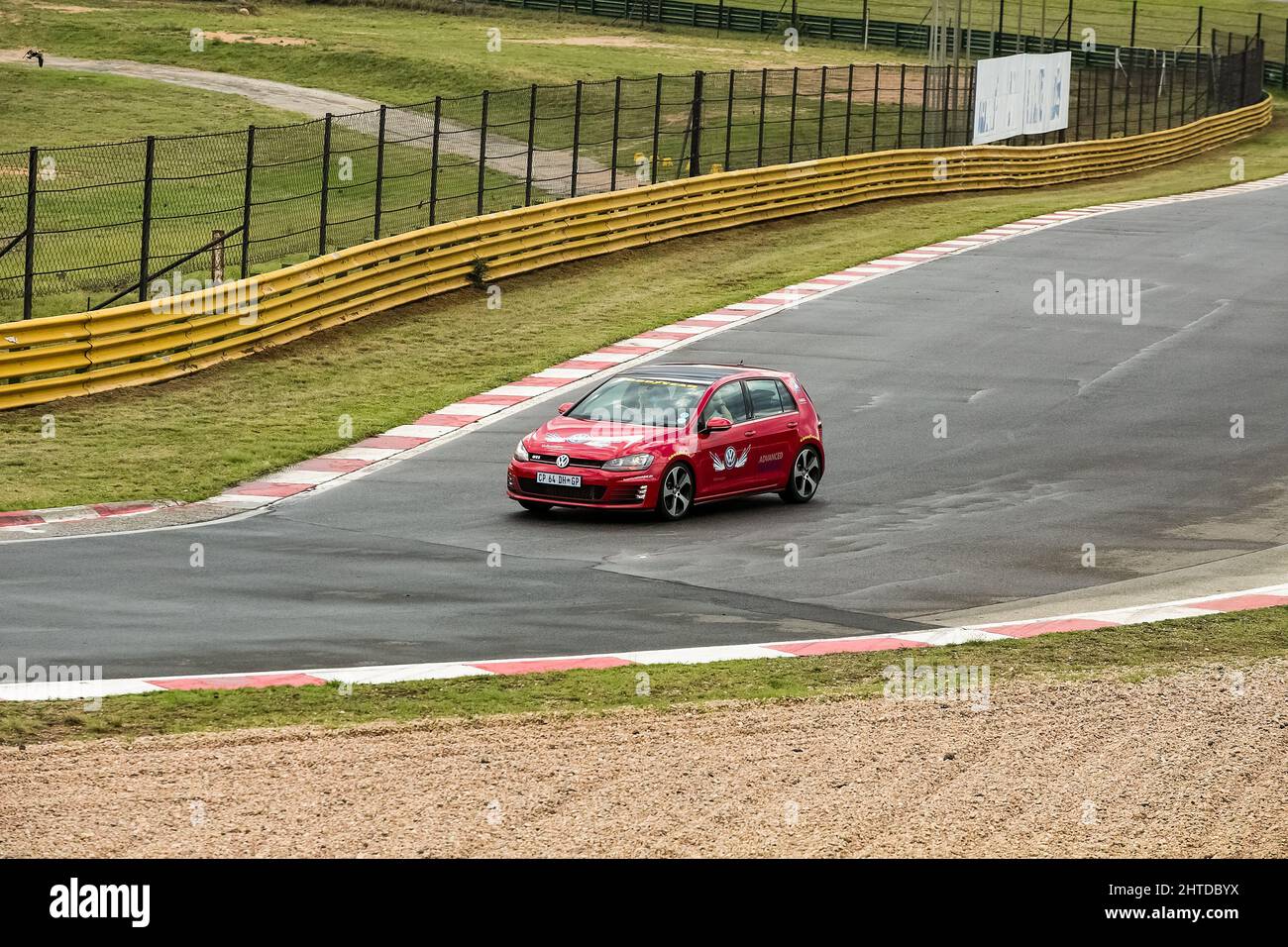 Red car driving in VW advanced driving instruction at Kyalami race