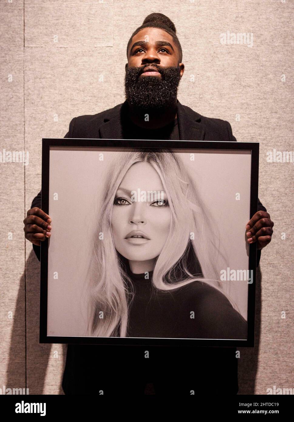 London, UK. 28th Feb, 2022. One of the star lots is the drawing by Kelvin Okafor. Kelvin Okafor with his hyper-realist drawing of fashion icon Kate Moss, created especially for the sale. The work has an estimate of £10,000-£15,000. The sale will take place on March 3rd. Credit: Mark Thomas/Alamy Live News Stock Photo