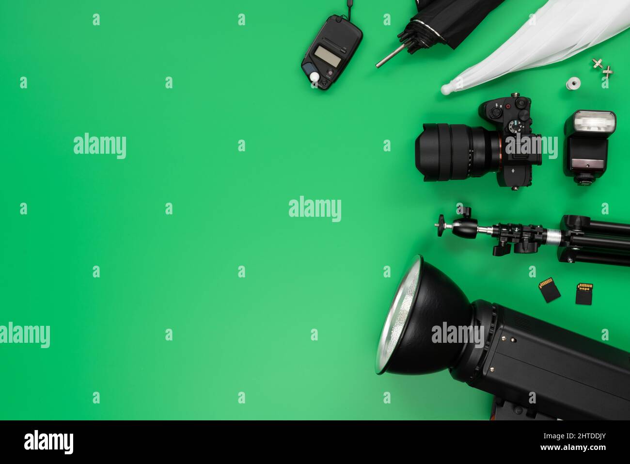 Green background table with some photography objects and accessories Stock Photo