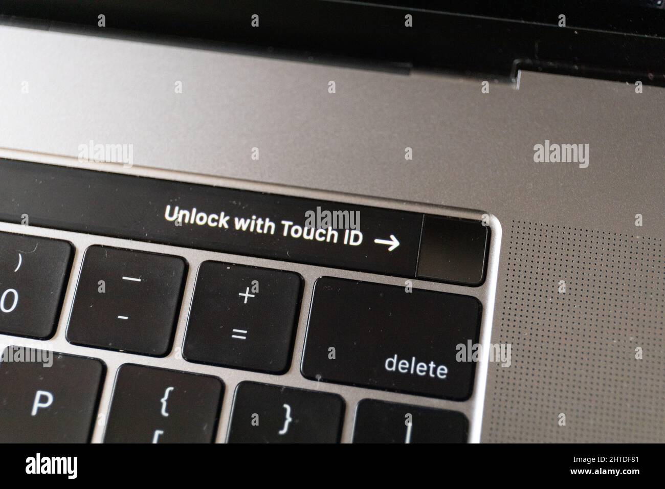 Top view of a fingerprint sensor on touch bar of MacBook Pro with sign