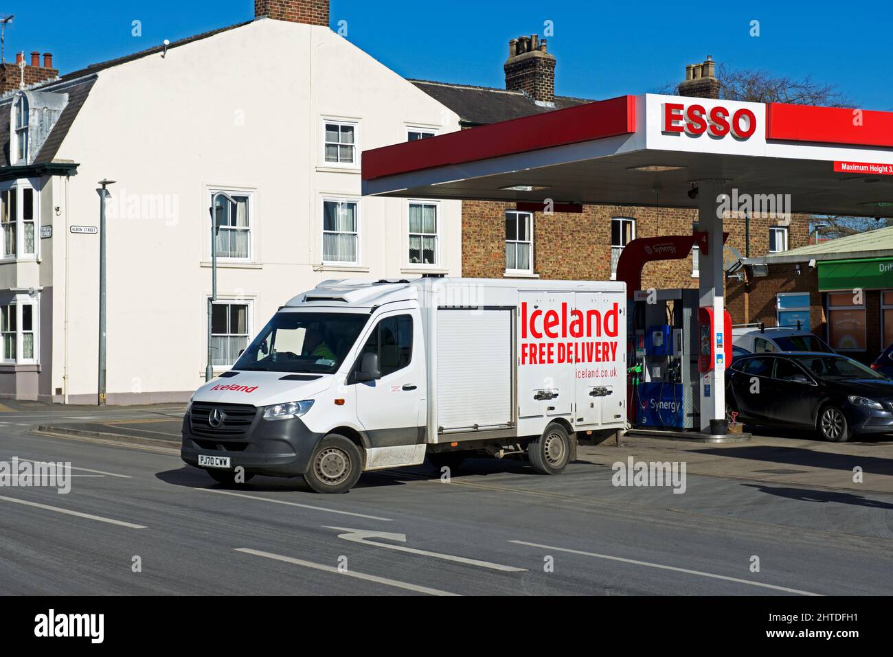 Iceland delivery van leaving Esso petrol station in Driffield, East Yorkshire, England UK Stock Photo