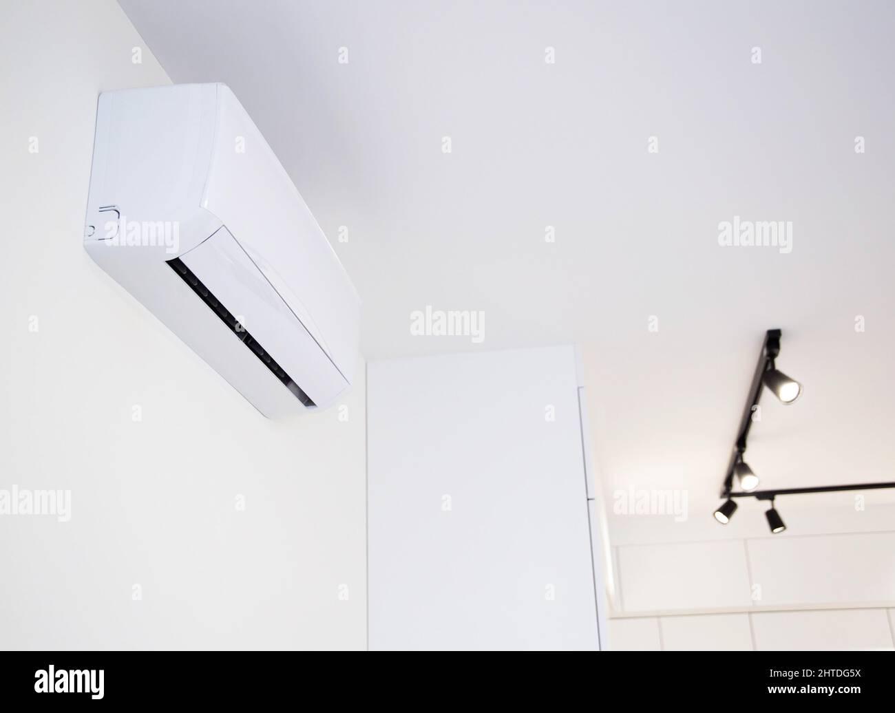 Modern wallmounted air conditioner in the apartment with heating and cooling capacity of the
