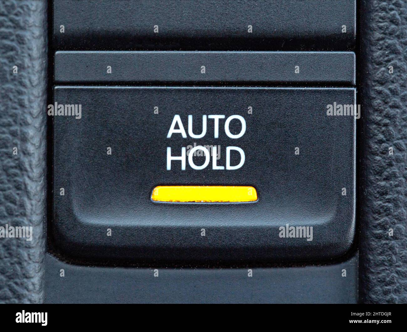 Button of a modern parking brake system in a car Stock Photo Alamy