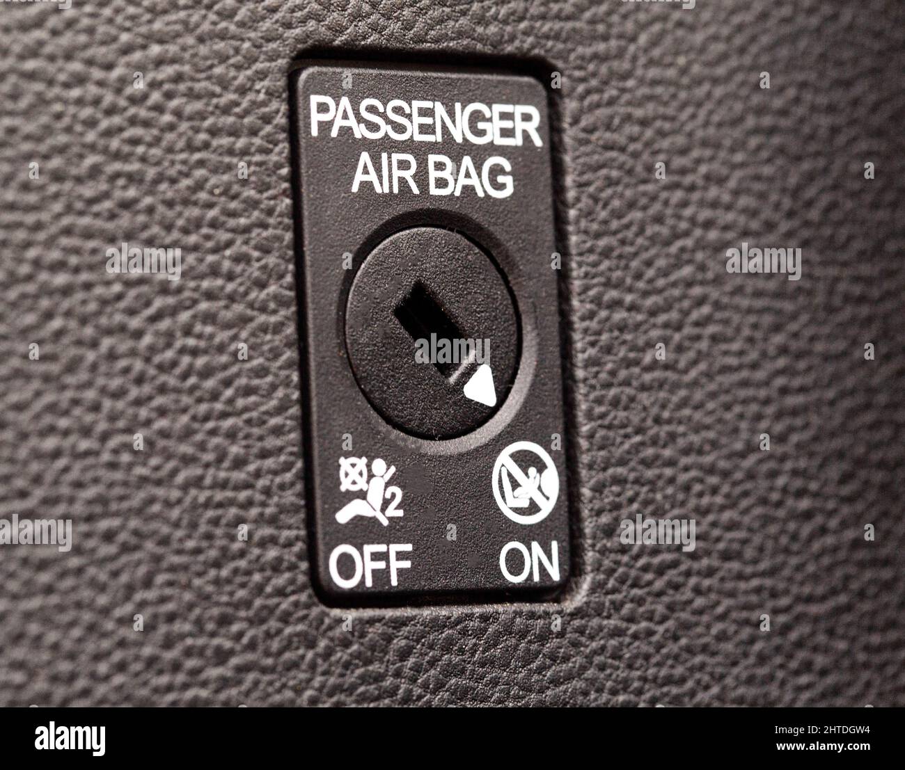 The switch on the panel of the car turns on and off the passenger airbag Stock Photo