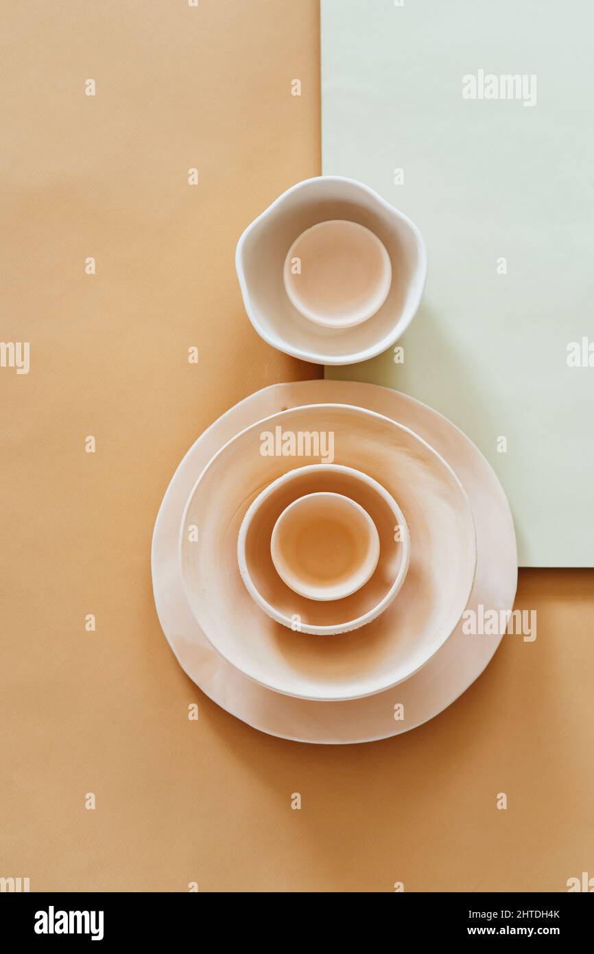 Ceramic bowls in shape of number eight on pastel background Stock Photo