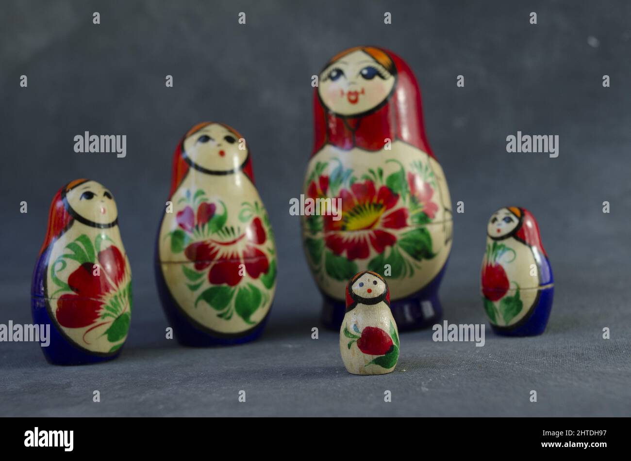 Five traditional Russian matryoshka dolls on gray background Stock